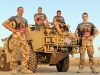 L/R GDSM Lee Baw,GDSM David Williams, GDSM Andy Beattie and GDSM Stephen Reece Dimmock, of 1 Battalion Welsh Guards (1 Bn WG) stand with a Jackal vehicle in Camp Bastion in Afghanistan wearing the t-shirts provided by British Forces Foundation for fathers day. They are serving on Operation Herrick 10 in Helmand province